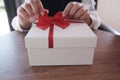 Woman hands wrapping gift box, unwrap or open present
