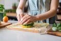 Woman hands wrapping a healthy sandwich in beeswax food wrap. Generative AI Royalty Free Stock Photo