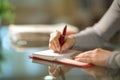 Woman hands writing on agenda in the night at home Royalty Free Stock Photo