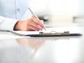 Woman hands writing on clipboard with a pen, isolated Royalty Free Stock Photo