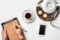 A woman hands writing on empty book note, diary, spread mockup, top view, studio. Cup of coffee break. Royalty Free Stock Photo