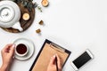 A woman hands writing on empty book note, diary, spread mockup, top view, studio. Cup of coffee break. Royalty Free Stock Photo