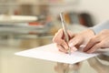 Woman hands writing letter on paper sheet on table Royalty Free Stock Photo