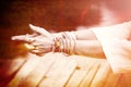 Woman hands in yoga symbolic gesture mudra lot of bracelets and Royalty Free Stock Photo