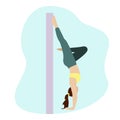 A woman in a handstand against the wall.