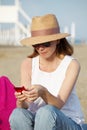 Woman with handy on the seaside Royalty Free Stock Photo