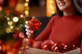 Woman hanging baubles on the Christmas tree