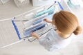 Woman hanging clean laundry on drying rack indoors, above view Royalty Free Stock Photo