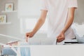 Woman hanging clean wet clothes laundry on drying rack at home laundry room Royalty Free Stock Photo