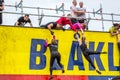 Woman hanging and climbiing a wall.