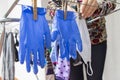 Woman hanging a homemade mask and rubber gloves