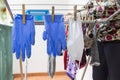 Woman hanging a homemade mask and rubber gloves