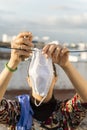 Woman hanging a homemade mask and rubber gloves