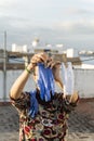 Woman hanging a homemade mask and rubber gloves