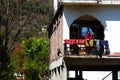 Woman hanging Laundry on balcony home of highlanders