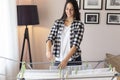 Woman hanging wet washed clothes on a drying rack Royalty Free Stock Photo