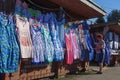 Woman hangs colored nightgowns and robes in the bazaar-market for sale