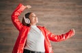 Woman, happiness and dancing with music headphones isolated on a wood background. Freedom, dance and female or person