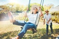 Woman, happy and fun on swing in retirement, playful and joy in summer vacation for quality time. Elderly people Royalty Free Stock Photo