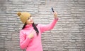 Woman happy girl taking self picture selfie with smartphone camera outdoors in autumn park Royalty Free Stock Photo