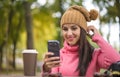 Woman happy girl taking self picture selfie with smartphone camera outdoors in autumn park Royalty Free Stock Photo