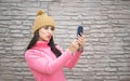 Woman happy girl taking self picture selfie with smartphone camera outdoors in autumn park Royalty Free Stock Photo