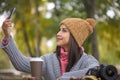 Woman happy girl taking self picture selfie with smartphone camera outdoors in park Royalty Free Stock Photo