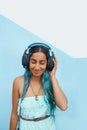 Woman, happy and headphones on for music, podcast or streaming before college, university or tertiary education. Person