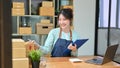 Woman happy with her sales order, sitting and working in her store