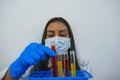 Woman happy scientist holding and paying attention skillful red chemical reaction in chemistry laboratory for science,