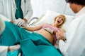 Woman hardly pushing to give child birth, natural labor and delivery