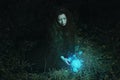 Woman harvesting magical flower in the forest