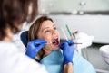 A woman has a dental check-up in dentist surgery.