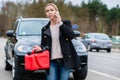 Woman has car with empty gas tank calling for help on phone Royalty Free Stock Photo