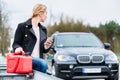 Woman has car with empty gas tank calling for help on phone Royalty Free Stock Photo