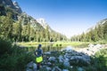 Woman has hands on hips as she enjoys and views the scenery at a pond along the Cascade Canyon Trail in Grand Teton National Park Royalty Free Stock Photo