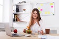 Woman has healthy business lunch in modern office interior Royalty Free Stock Photo