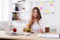 Woman has healthy business lunch in modern office interior