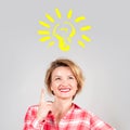 Woman has an idea, showing finger up on light bulb Royalty Free Stock Photo