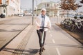 A woman has rented an electric scooter and is planning to ride on a sunny winter day in Denmark, Copenhagen. Ecological clean