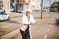 A woman has rented an electric scooter and is planning to ride on a sunny winter day in Denmark, Copenhagen. Ecological clean