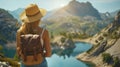 woman with a hat and backpack looking at the mountains and lake from the top of a mountain Royalty Free Stock Photo