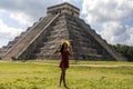 Woman with hat in the castle and temple of Chichen Itza known as the famous and apocalyptic Mayan pyramid of Mexico Royalty Free Stock Photo