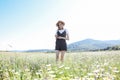 beautiful woman in a hat in a field of chamomile flowers Royalty Free Stock Photo