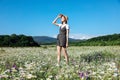 beautiful woman in a hat in a field of chamomile flowers Royalty Free Stock Photo