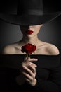 Woman in Hat holding Rose Flower in Hands, Fashion Model Beauty Royalty Free Stock Photo