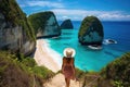 Woman with hat on the island of Phi Phi, Krabi, Thailand, rear view of a Woman walking at Kelingking Beach in Nusa penida island, Royalty Free Stock Photo