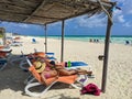 Woman in a hat lies on a blue chaise longue on a towel and admires the azure ocean.Cayo Coco, Cuba Royalty Free Stock Photo