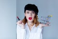 Woman in hat with lipstick for makeup and shopping cart Royalty Free Stock Photo