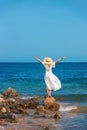 A woman in a hat looks at the sea. Selective focus. Royalty Free Stock Photo
